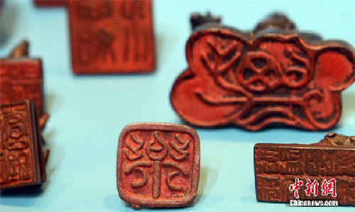 Copper Chinese Zodiac stamps shown in SE China