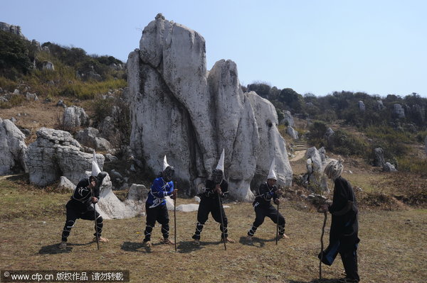 Yi folk artists perform ancient drama