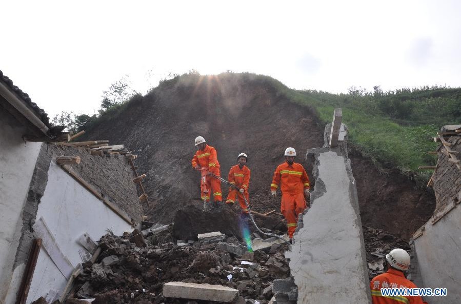 Rescuers search for trapped people at landslide site in Guizhou