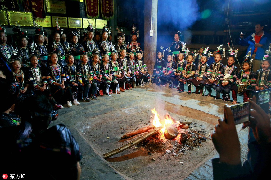 Locals sing around a fire