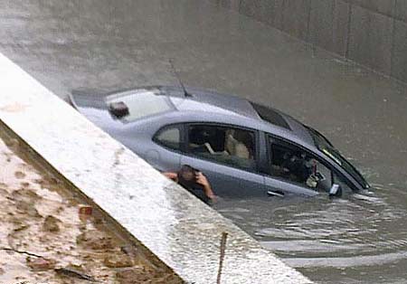 In a flash, car sinks in rainwater