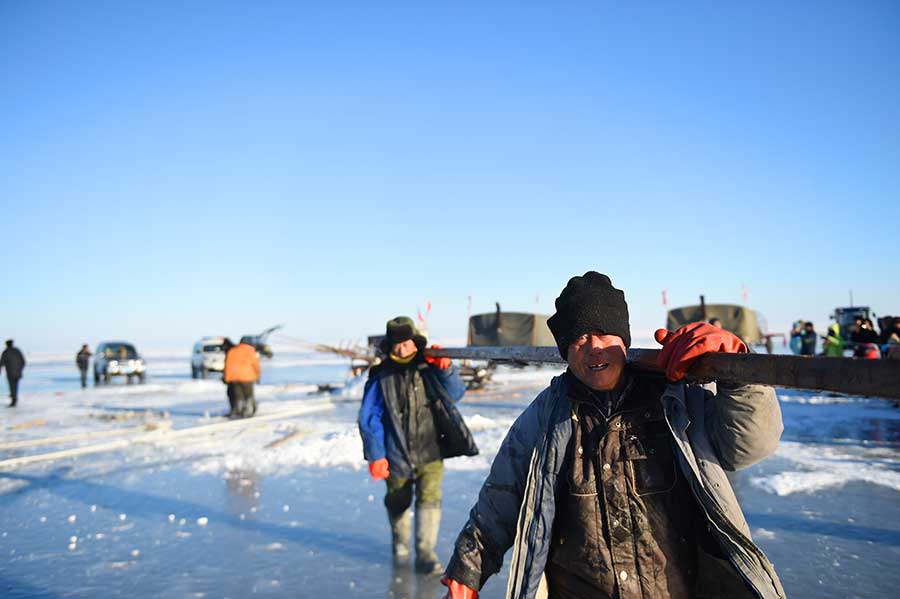 Winter fishing in ice-covered Hulun Lake in Inner Mongolia