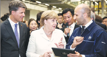 Merkel experiences smart manufacturing at BMW production base