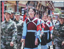 Women in ethnic costumes patrol Lijiang Ancient Town