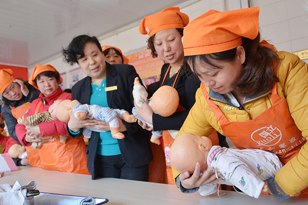 Nannies learn how to take care of babies at a training center in Jimo