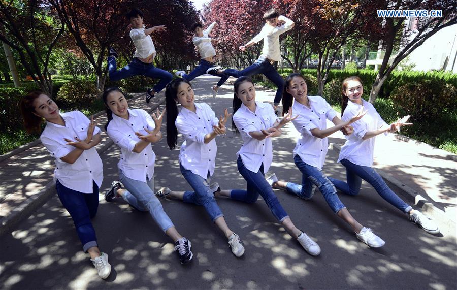 Students pose for graduation photo with performance