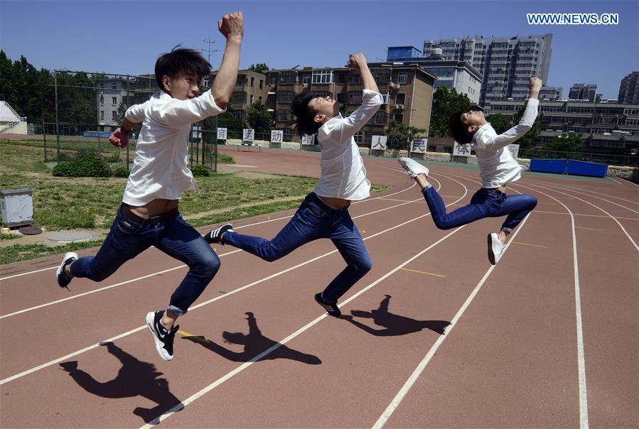 Students pose for graduation photo with performance