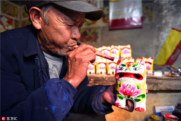 70-year-old villager devoted to painted clay sculpture