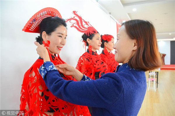 Traditional paper-cutting adds festive touch to qipao