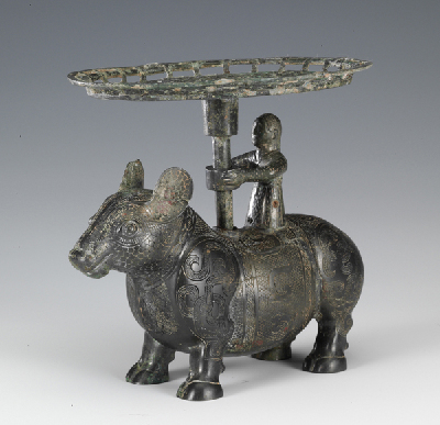 Plate held by a woman standing on the back of an ox