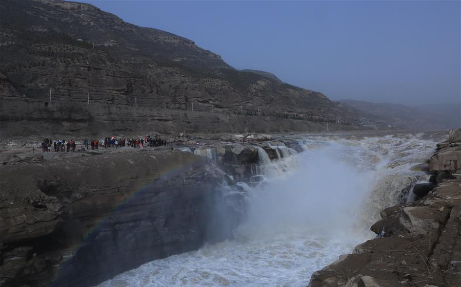 Surging water at Hukou Waterfall attracts tourists