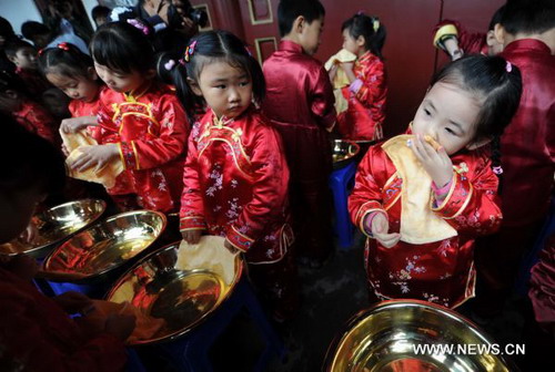 Chilidren take part in traditional first writing ceremony