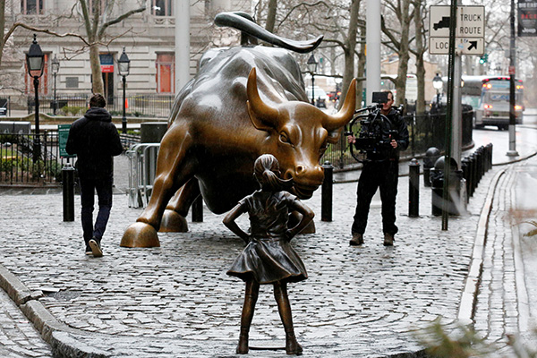 Fearless Girl stares iconic Charging Bull