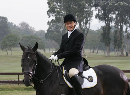 Hong Kong action movie star Jackie Chan poses with a horse in this photo taken on Feb.11, 2008, seen in his official blog, as he films a promotional video for the Beijing 2008 Olympic equestrian events to be held in Hong Kong. [Agencies]