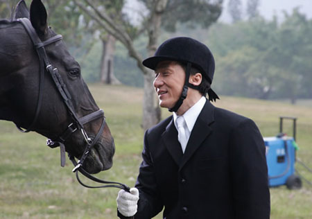 Hong Kong action movie star Jackie Chan smiles at a horse in this photo taken on Feb.11, 2008, seen in his official blog, as he films a promotional video for the Beijing 2008 Olympic equestrian events to be held in Hong Kong. [Agencies]