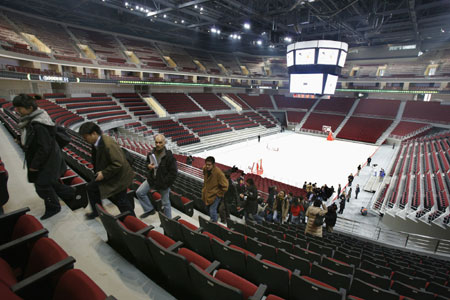 Journalists leave the Beijing Olympic Basketball Gymnasium after a media tour at the Wukesong Culture and Sports Center in Beijing February 19, 2008. The gymnasium, which has a seating capacity for 18,000 people, will host basketball competitions during the 2008 Beijing Olympic in August.