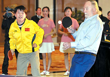 Tim Boggan, a member of the original US team that took part in 'Ping-pong diplomacy' in 1971, joins forces with former Chinese world champion Qiao Hong in a friendly game at a signing ceremony in South China's Guangzhou, Feb. 24, 2008. At the event, Chinese sportswear company Li Ning announced it has signed a sponsorship deal with the US national table tennis team for the next five years. [Xinhua]