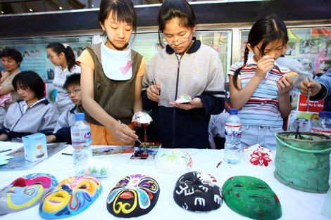 Students at a school in the Dongcheng district of Beijing make traditional Peking Opera masks in this file photo. [China Daily]