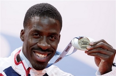 Britain's Dwain Chambers displays his bronze medal during the medal ceremony for the Men's 60m at the Athletics World Indoor Championships in Valencia, Spain, Saturday, March 8, 2008. British Olympic Association (BOA) chairman Colin Moynihan said on Wednesday he would oppose any attempt by sprinter Dwain Chambers to compete at the Beijing Games.