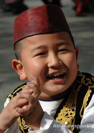 Ma Lin, a boy of the Hui ethnic group, smiles as he plays with other pupils at Lanzhou Qing Hua Primary School, in Lanzhou, capital of Northwest China's Gansu Province, March 15, 2008. The Beijing Organizing Committee for the Olympic Games (BOCOG) recently invited the school, which is known for having students from many ethnic groups, to submit photographs of smiling children for possible use in the August 8 Opening Ceremony of the Beijing Olympic Games. BOCOG started collecting photographs of children's smiling faces from around the world on Sept 4 last year. [Asianewsphoto] 