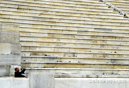 A visitor takes a photo of the Panathenaic Stadium in Athens, where the first modern Olympics were held in 1896, in this photo taken on March 20, 2008. The Olympic flame, which will be lit on March 24 in Olympia, Greece, will be handed over to the Beijing Olympic Committee on March 30 at a ceremony in the Panathenaic Stadium made of marble. [Asianewsphoto]