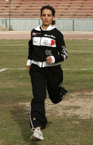 Iraqi sprinter Dana Abdul-Razzaq runs during a training session at al-Shaab National Stadium in Baghdad March 18, 2008. Abdul-Razzaq will be Iraq's only female athlete at the Beijing Olympics. [Agencies]