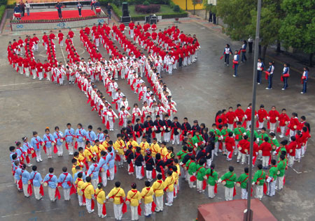 A group of pupils form the Olympic rings in a Nanchang primary school in East China&apos;s Jiangxi Province, March 31, 2008. The school encouraged students to do Olympic-themed activities to celebrate the upcoming Games. [Xinhua]