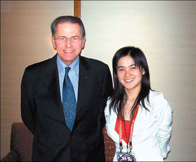 Qi Xiaoying (R) and president of the International Olympic Committee Jacques Rogge. [China Daily]