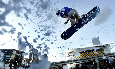 Australian snowboarder Ben Metes flys off the end of a snow jump in central Sydney March 9, 2006. The promotional event was staged on a ramp covered with man-made snow on a day when the temperature is expected to reach 32 degrees celcius (90 fahrenheit). [Reuters]