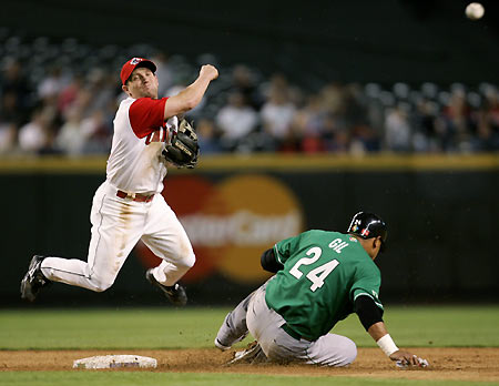 Canadian second baseman Stubby Clapp leaps over Mexico's Geronimo Gil to out Miguel Ojeda for a third inning double play at the 2006 World Baseball Classic in Phoenix, Arizona March 9, 2006.[Reuters]