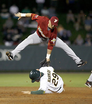 Venezuela's second baseman Marco Scutaro (top) tags out Australia's Bradley Harman during a steal attempt at second base in the third inning during their World Baseball Classic first round game in Kissimmee, Florida March 9, 2006.[Reuters]