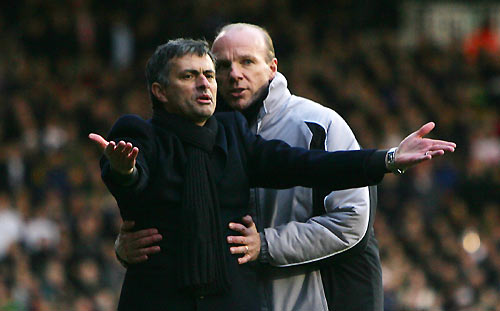 Chelsea's manager Jose Mourinho (L) is restrained by the fourth official after a Didier Drogba (unseen) goal was disallowed during their English Premier League soccer match against Fulham at Craven Cottage in London March 19, 2006. [Reuters]