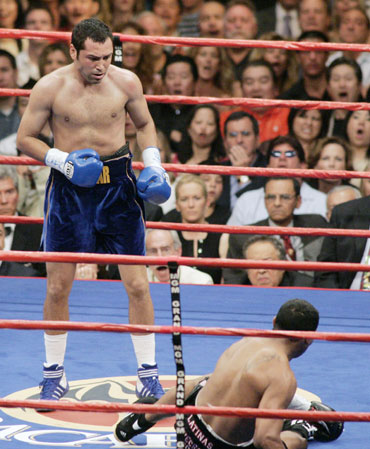 Oscar De La Hoya (L) of Los Angeles stands over Ricardo Mayorga of Managua, Nicaragua after knocking him down in the first round of their WBC Super Welterweight title fight at the MGM Grand Garden Arena in Las Vegas, Nevada May 6, 2006. De La Hoya won the fight by TKO in the sixth round. 