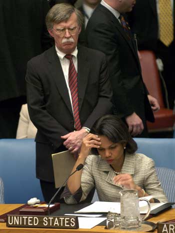 U.S. Ambassador to the U.N. John Bolton watches as U.S. Secretary of State Condoleezza Rice reads at the United Nations Security Council in New York May 9, 2006. REUTERS/Chip East