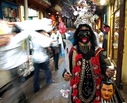 Rana Bhattacharya, an unemployed youth, walks down a busy lane dressed up as the Hindu goddess Kali ( the Goddess of power) in the eastern Indian city of Kolkata May 9, 2006. 