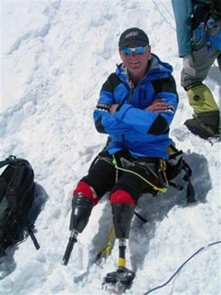 In this photo released by Mark Inglis, New Zealander Mark Inglis has a rest during on his climb up Mount Everest, Nepal, in April 2006. Inglis became the first double amputee to reach the summit of Mount Everest on Monday, May 15, 2006. Inglis, 47, had both legs severed just below the knee after suffering frostbite when he was trapped by storms while climbing New Zealand's highest peak, Mount Cook, in 1982. He reached the peak of the world's tallest mountain late Monday, phoning his wife Anne to say he'd made it and had returned to his party's base camp. [AP Photo]