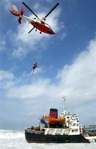 A helicopter lifts a crew members off an oil tanker which ran aground, May 17, 2006, in Kaoshiung, 350 kilometers (217 miles) south west of Taipei. The tanker ran aground in stormy seas swollen by typhoon Chanchu. The typhoon, the strongest ever reported in the South China Sea in May, was expected to pass between Hong Kong and Taiwan on Wednesday and slam into Guangdong province on Thursday morning. [AP Photo]