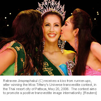 Ratravee Jirapraphakul (C) receives a kiss from runner-ups Sophananat Utomkul (R) and Aphirada Terachanukul, after winning the Miss Tiffany's Universe transvestite contest, in the Thai resort city of Pattaya, about 150 km (93 miles) southeast of Bangkok May 20, 2006. Thirty contestants entered the contest this year, which aims to promote a positive transvestite image internationally. [Reuters]