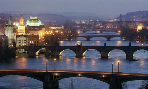 Dusk settles on bridges that cross the Moldau River in central Prague. For couples interested in European travel, the Czech capital is an increasingly popular destination.