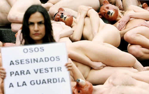 Nude PETA (People for the Ethical Treatment of Animals) activists protest against the Queen's palace guards' bearskin hats at Peter's Hill in central London May 21, 2006. The banner reads "Bears slaughtered for the Queen's guards". [Reuters]