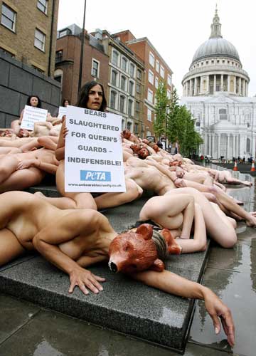 Nude PETA (People for the Ethical Treatment of Animals) activists protest against the Queen's palace guards' ceremonial bearskin hats at Peter's Hill in central London, near the St. Paul's Cathedral, May 21, 2006. 