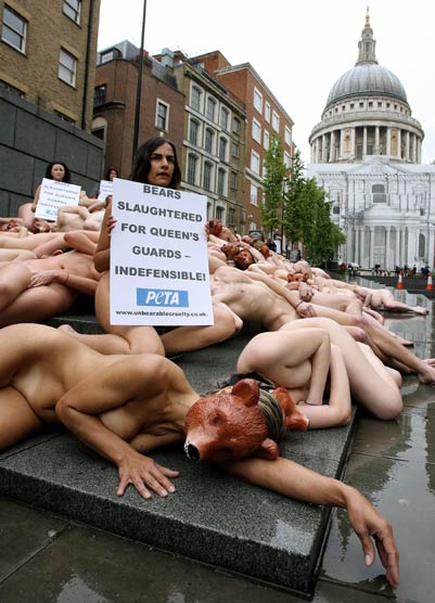 Nude PETA (People for the Ethical Treatment of Animals) activists protest against the Queen's palace guards' bearskin hats at Peter's Hill in central London May 21, 2006. The banner reads "Bears slaughtered for the Queen's guards". 