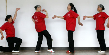 Elderly women practice the imitation of shadow play at a gym in Tangshan, north China's Hebei province June 6, 2006. Ten elderly women amateur dancers from Tangshan, who wanted to make the most of their retired life instead of staying at home, formed the troupe, with the oldest at the age of 74, local media reported. [Reuters]