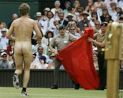 Military stewards move in to cover up an unidentified streaker who interrupted the Women's Singles quarter-final match between Maria Sharapova and Elena Dementieva, both of of Russia, on the Centre Court at Wimbledon, Tuesday, July 4, 2006. [AP Photo]