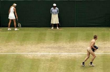 Russia's Maria Sharapova (L) watches a streaker (R) who interrupted her quarter-final match with Russia's Elena Dementieva at the Wimbledon tennis championships in London July 4, 2006. [Reuters] 