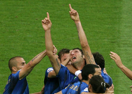 Italy's Marco Materazzi (gesturing) celebrates with team mates after scoring their first goal against France during their World Cup 2006 final soccer match in Berlin July 9, 2006. [Reuters]