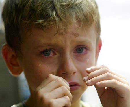 A Russian boy cries as he evacuates Beirut with his mother, leaving behind his Lebanese father, July 18, 2006. U.N Secretary-General Kofi Annan said on Tuesday he expects European nations to contribute troops to a proposed stabilisation force to end fighting in south Lebanon.