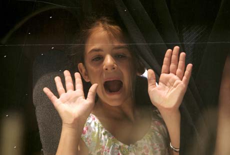 An unidentified girl calls her mother to board a bus evacuating civilians from Beirut during a massive evacuation operation July 18, 2006. 