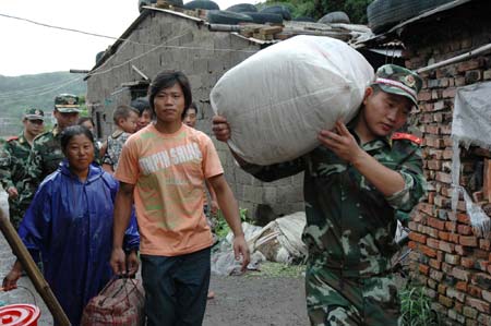 Chinese maritime police evacuate residents before the coming of Saomai in Wenzhou, East China's Zhejiang Province August 10 2006. At least 571,376 people in China -- 305,376 in Zhejiang and 266,000 in Fujian -- have been evacuated, from the path of Typhoon Saomai, which has upgraded to extremely powerful, Xinhua reported.[Xinhua] Detail