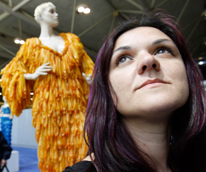 Brazilian artist Adriana Bertini poses with one of her dresses made of condoms on exhibit at the International AIDS Conference in Toronto August 17, 2006. The exhibit aims to get people comfortable about condoms, especially those living in countries where the little piece of latex is considered taboo. [Reuters] 